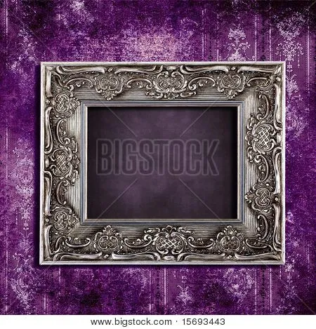 Intricate old frame hanging on grungy violet vintage wallpaper ... Intricate old frame hanging on grungy violet vintage wallpaper ...