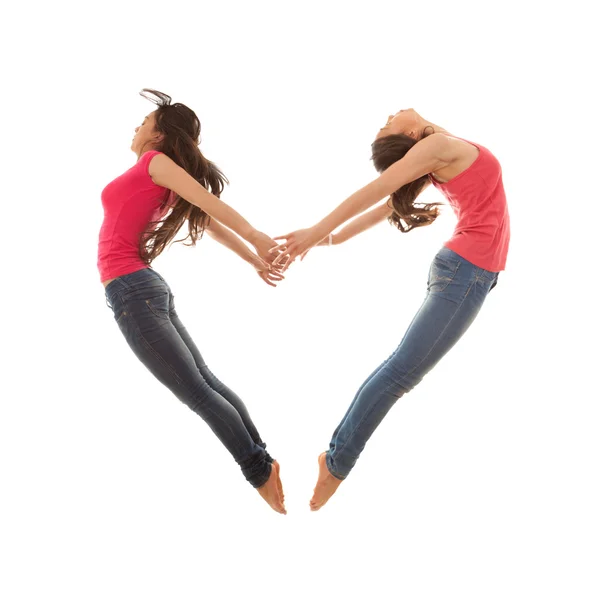 Las mujeres saltando en forma de corazón — Foto stock ...
