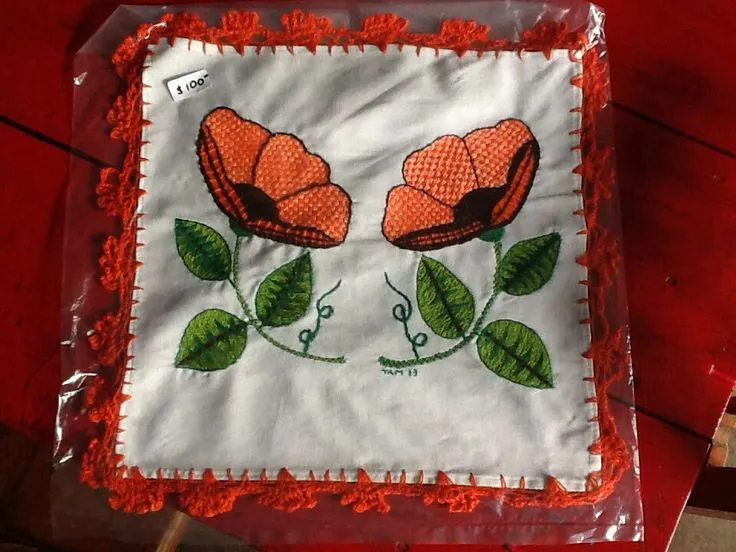 Orange flowers tortilla cloth done in weaved embroidery. Flores ...