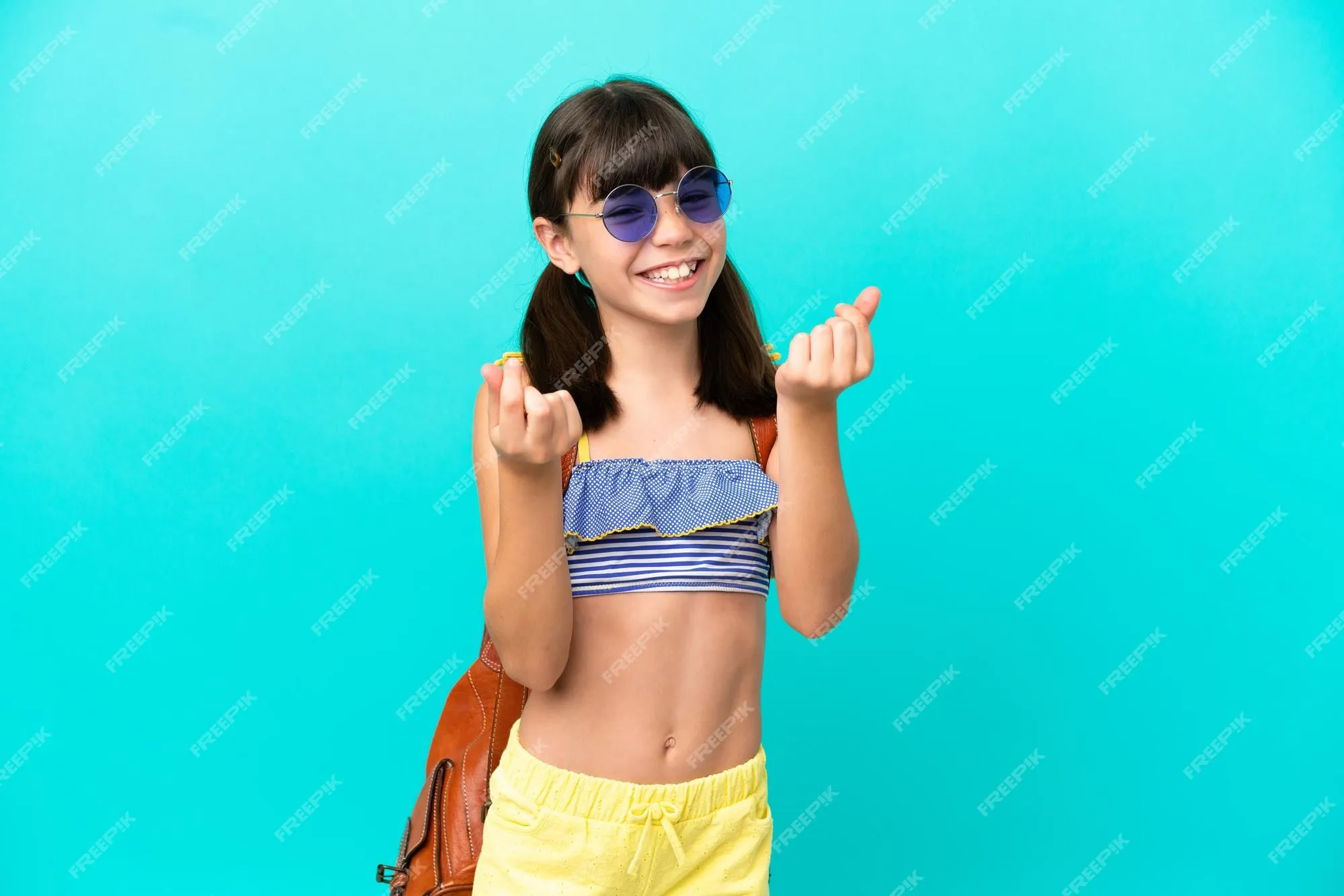 Premium Photo | Little caucasian kid going to the beach isolated on blue  background making money gesture
