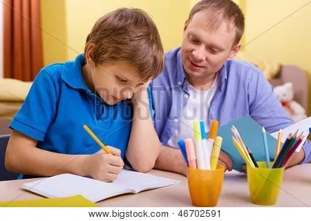 Retrato de niño lindo y su padre haciendo tareas escolares en casa ...