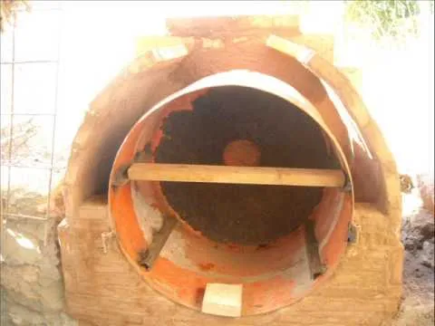 Construcción de un horno de leña con barro y un tambor de metal ...