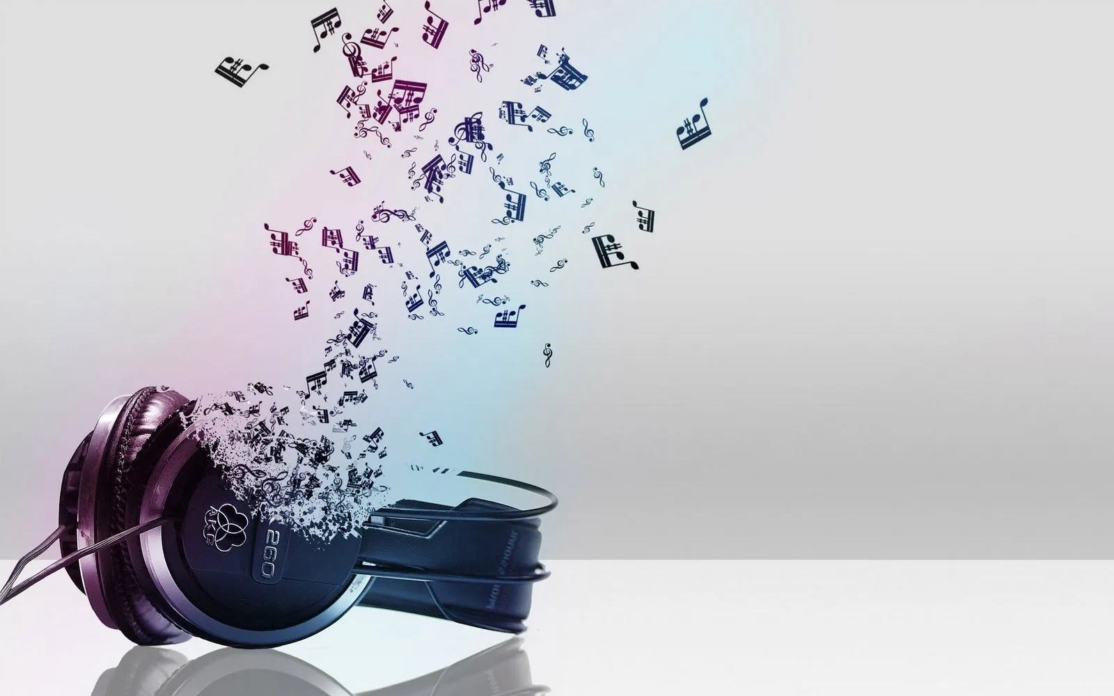 Fondo de pantalla con música saliendo de unos auriculares Fondo de pantalla con música saliendo de unos auriculares