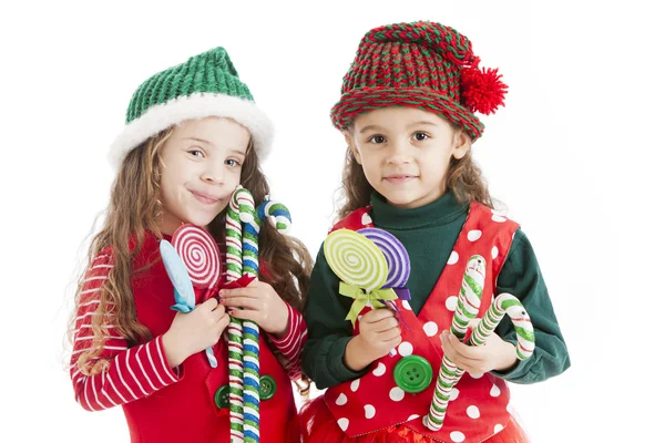 dos pequeños duendes de Navidad sostienen bastones de caramelo y ventosas — Imagen de stock #21427391. dos pequeños duendes de Navidad sostienen bastones de caramelo y ventosas — Imagen de stock #21427391.